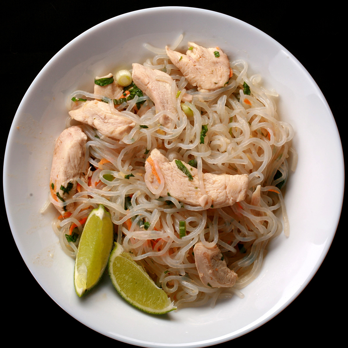 A plate of paleo chicken pad thai, made with shirataki noodles.