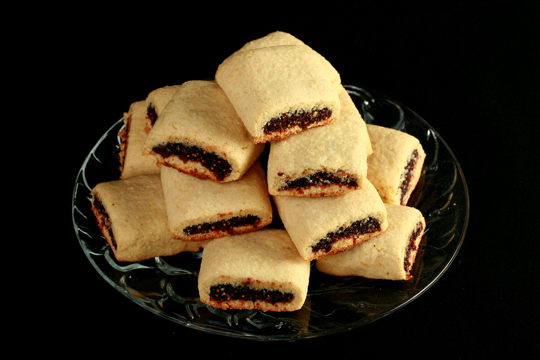 A small glass plate piled high with gluten-free fig newtons.