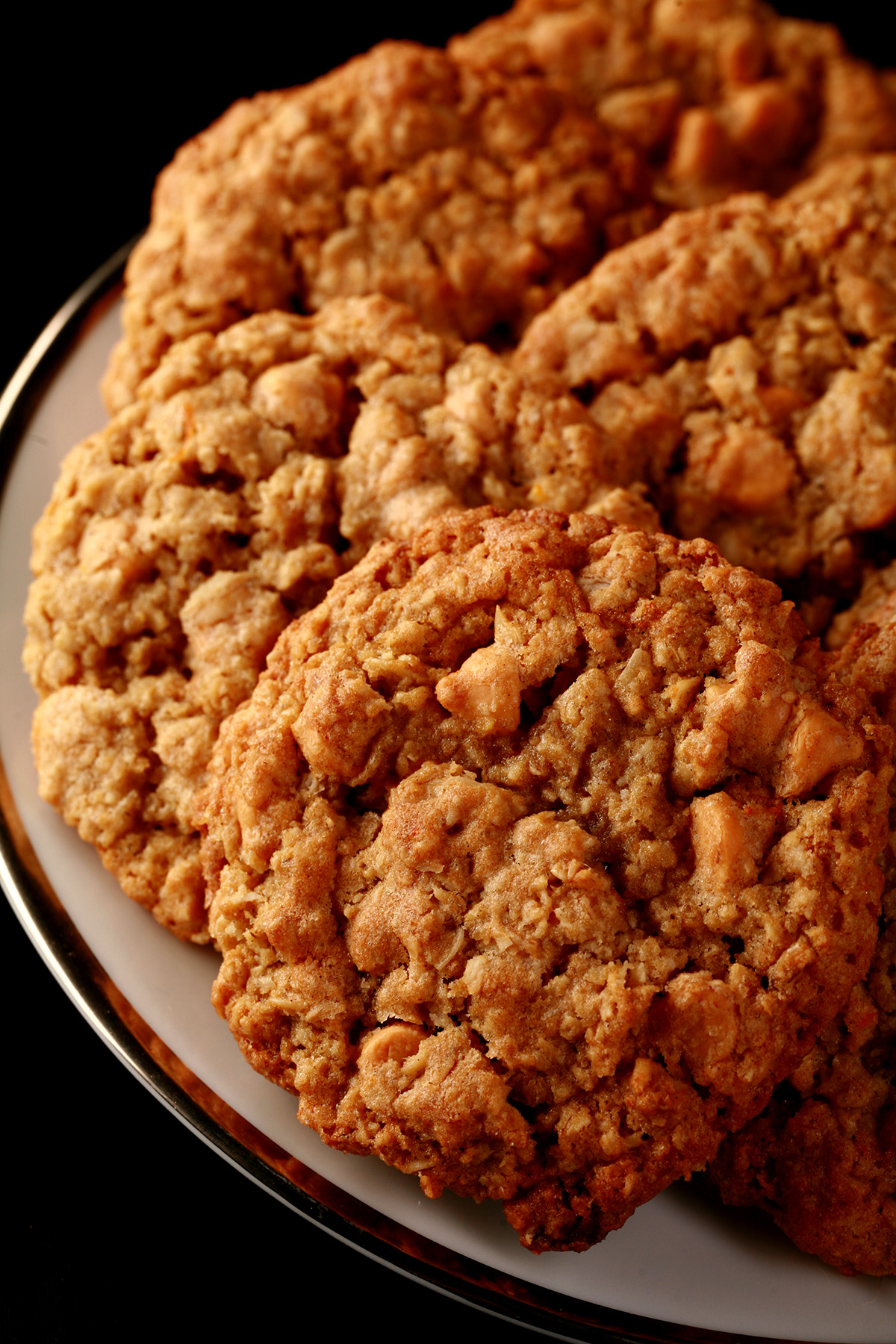 Close up photo of a plate of gluten-free oatmeal cookies with visible butterscotch chips