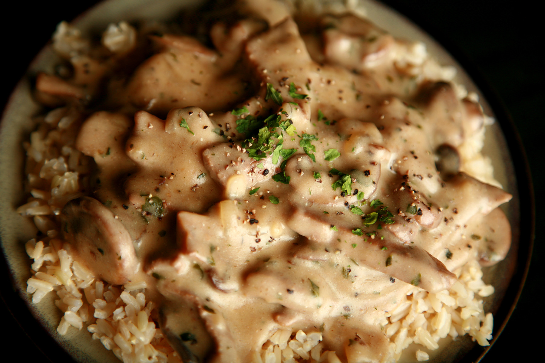 A plate of gluten-free beef stroganoff over rice.