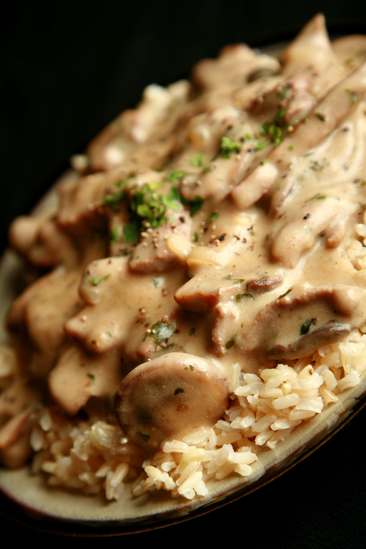 A plate of gluten-free beef stroganoff over rice.