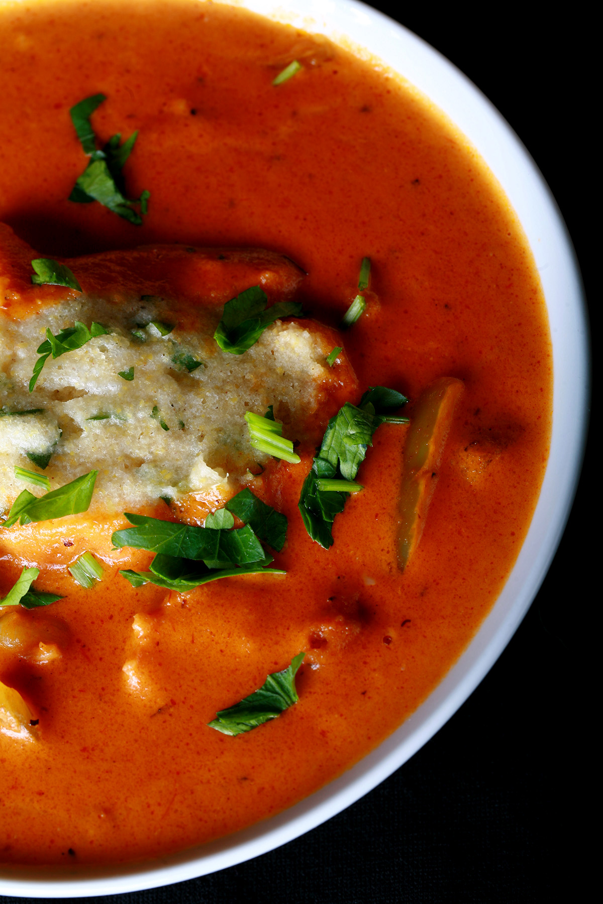 A bowl of gluten-free creamy creole soup with cornmeal dumplings.