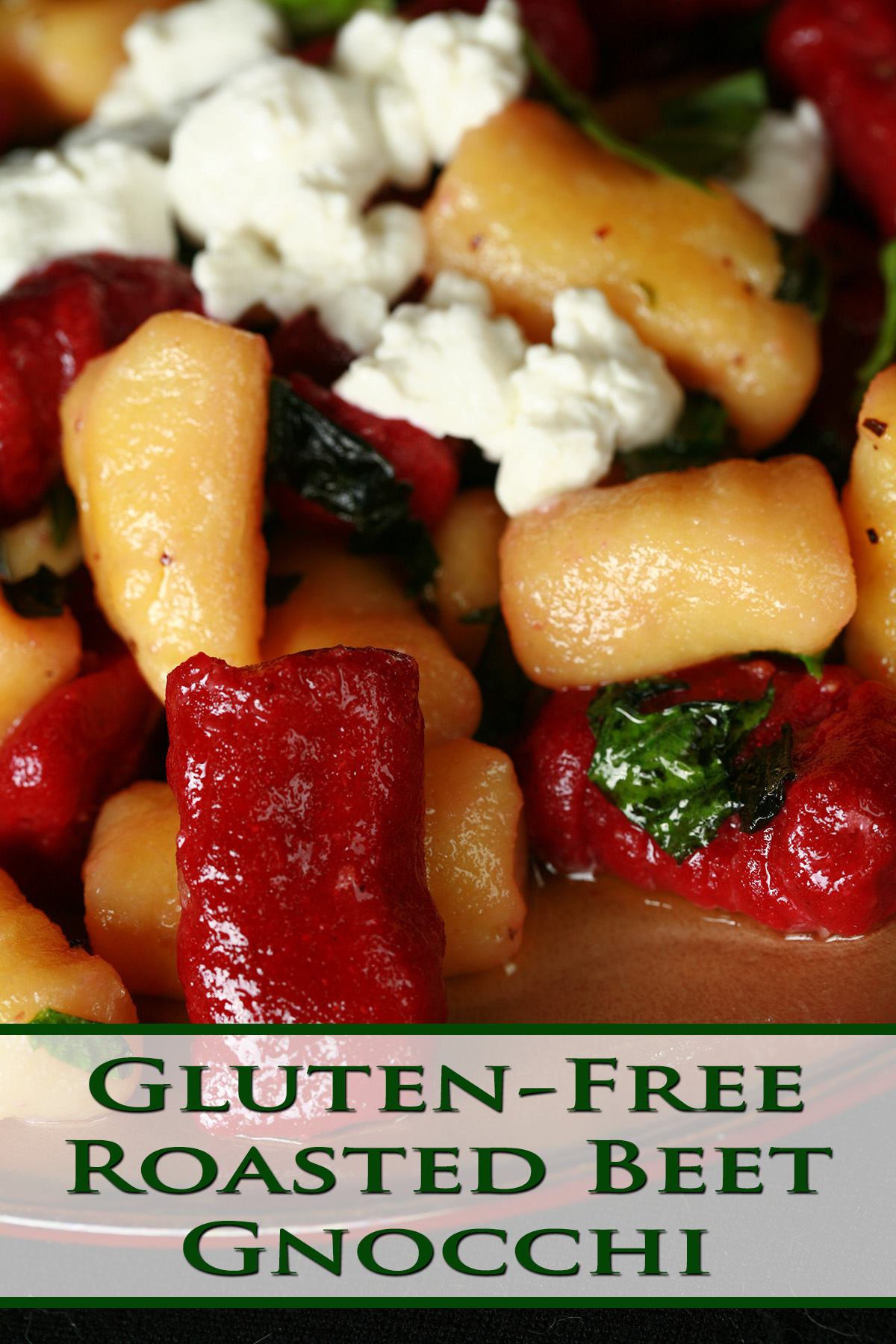 A plate of red and yellow roasted beet gnocchi. It's topped with crumbled goat cheese and fresh basil.