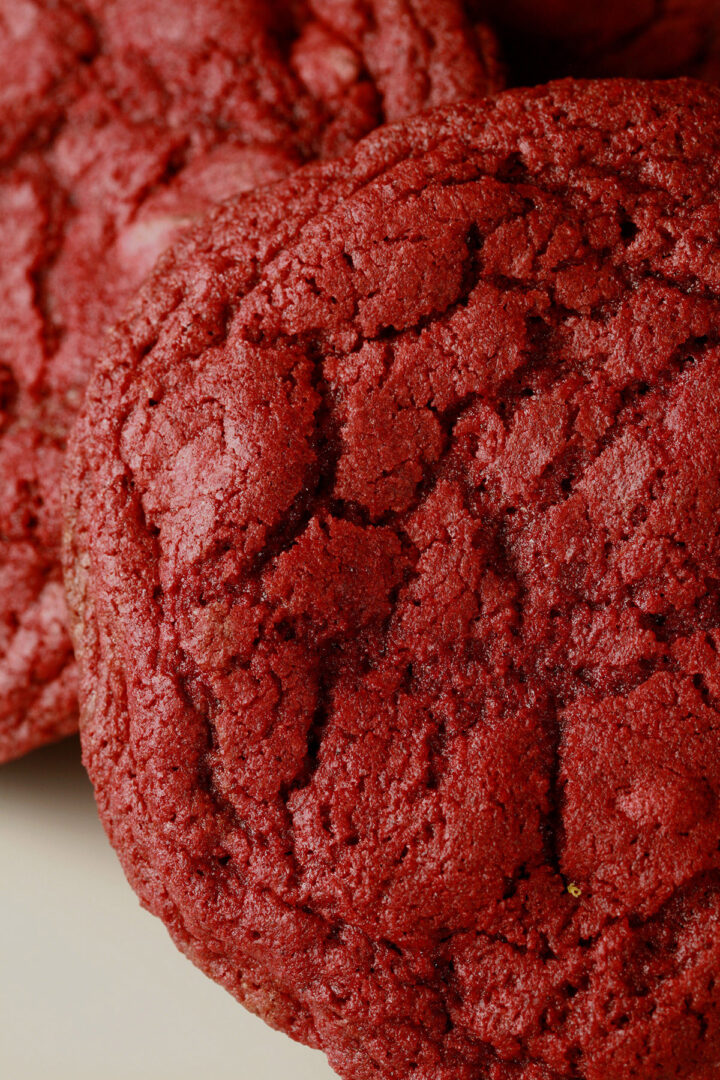 A close up photo of a plate of gluten-free chewy red velvet cookies.