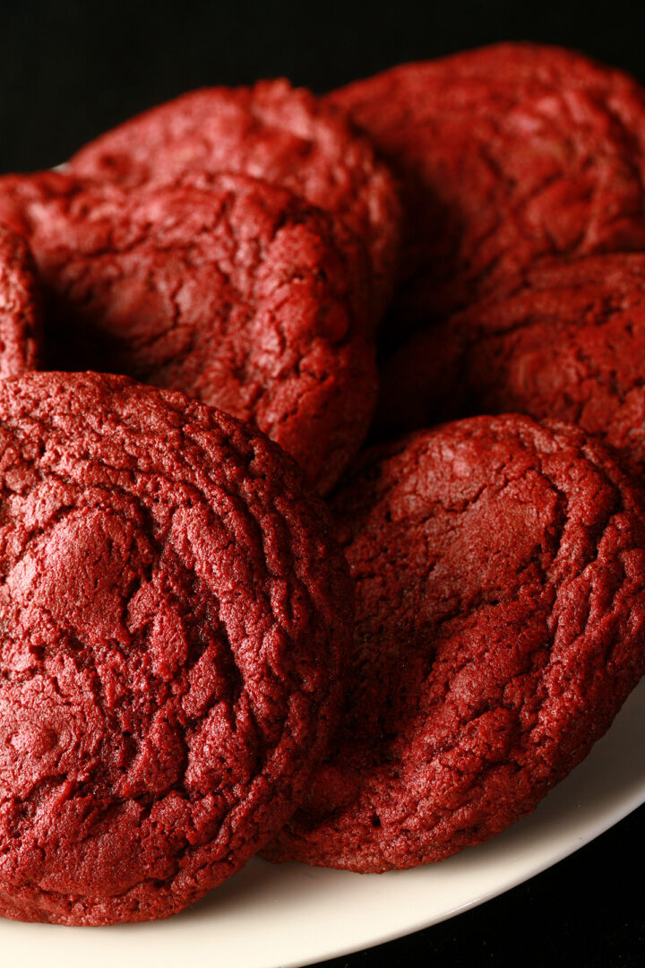 A close up photo of a plate of gluten-free chewy red velvet cookies.