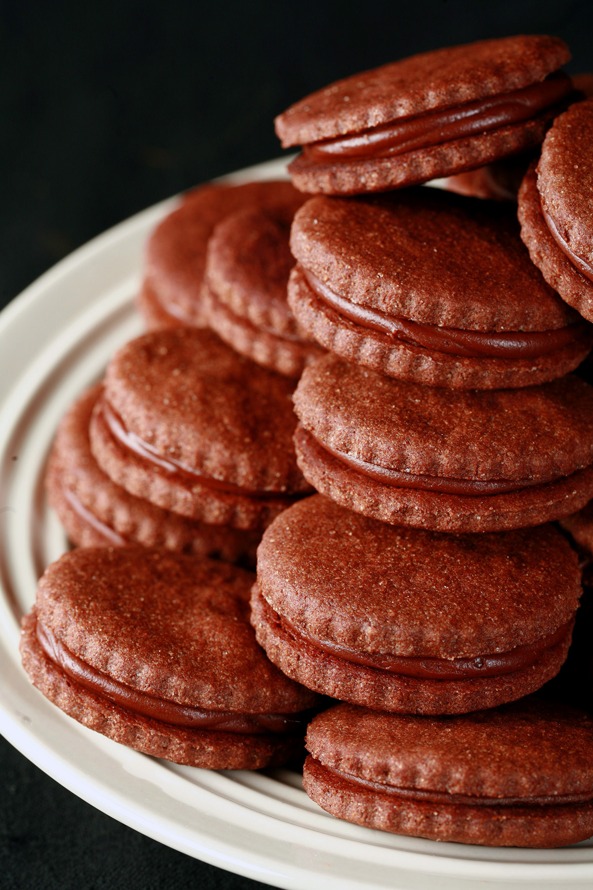 A plate of gluten free chocolate sandwich cookies.