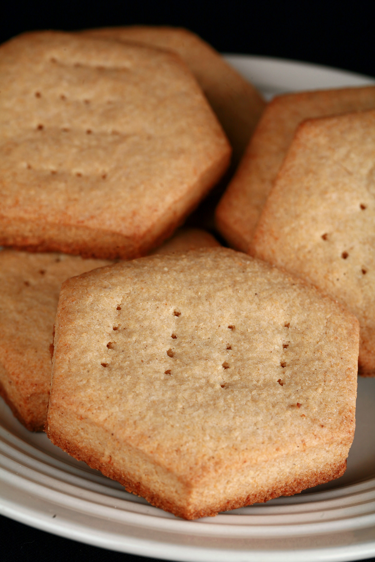 A plate of hexagonal gluten-free shortbread cookies.