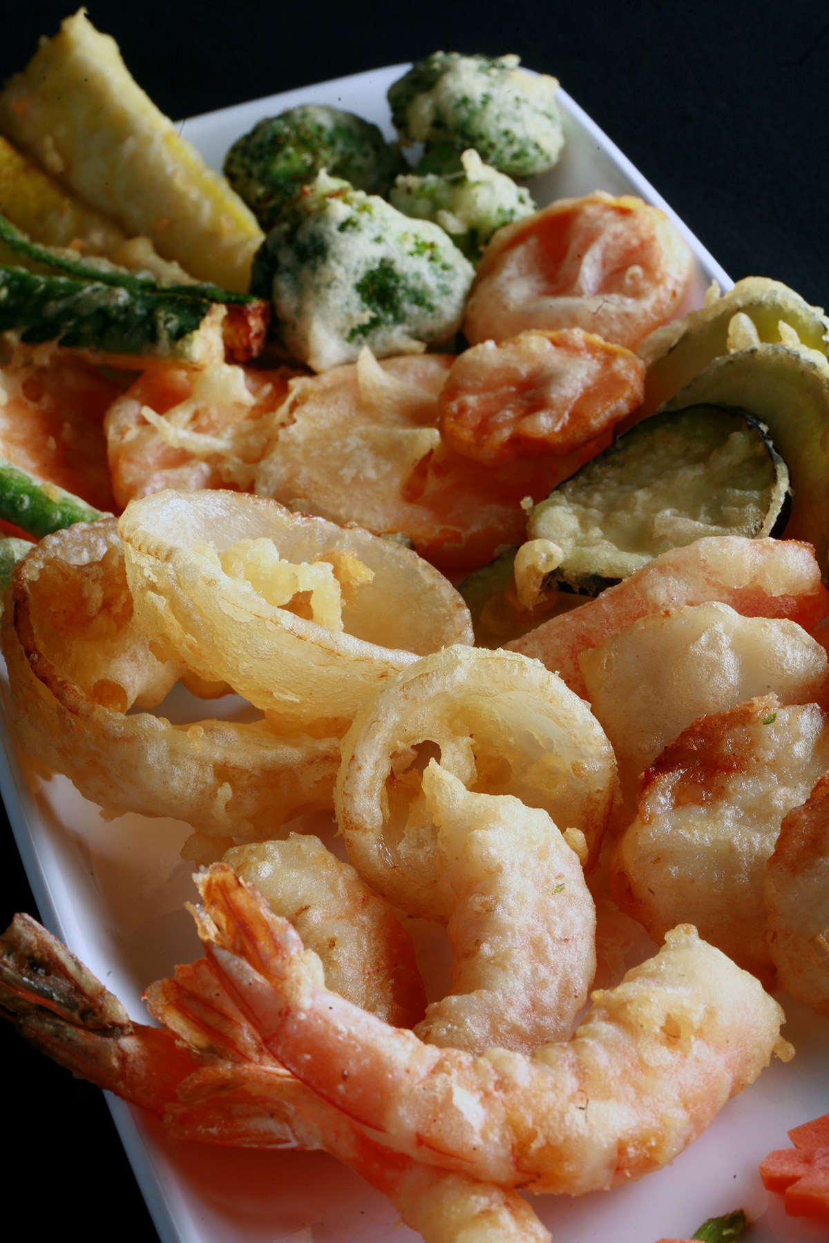 A tray of gluten free tempura shrimp and vegetables.