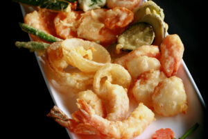 A tray of gluten-free tempura shrimp and vegetables.