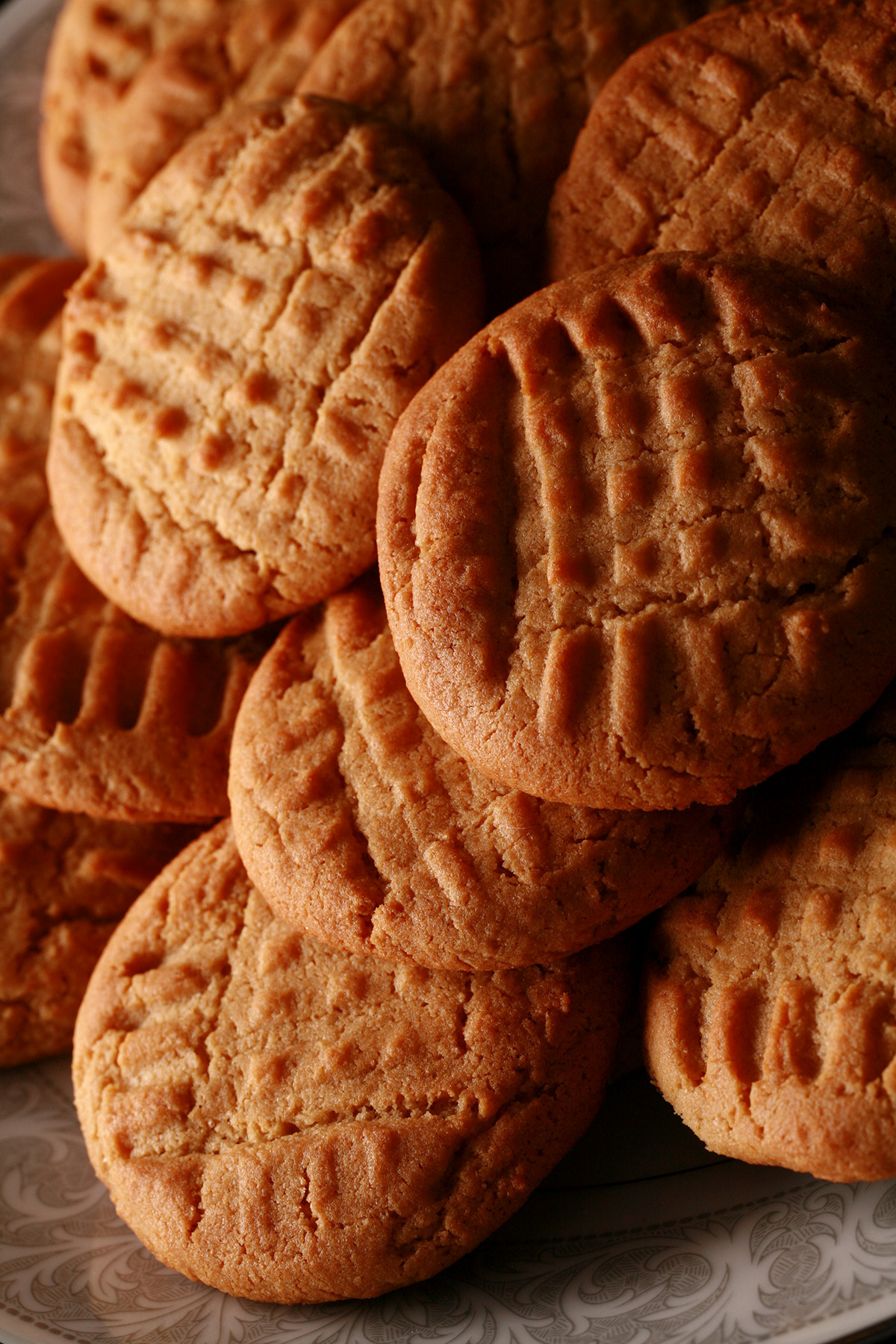 A plate of soft and chewy gluten-free peanut butter cookies.