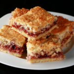 A plate of gluten-free raspberry coconut squaress.