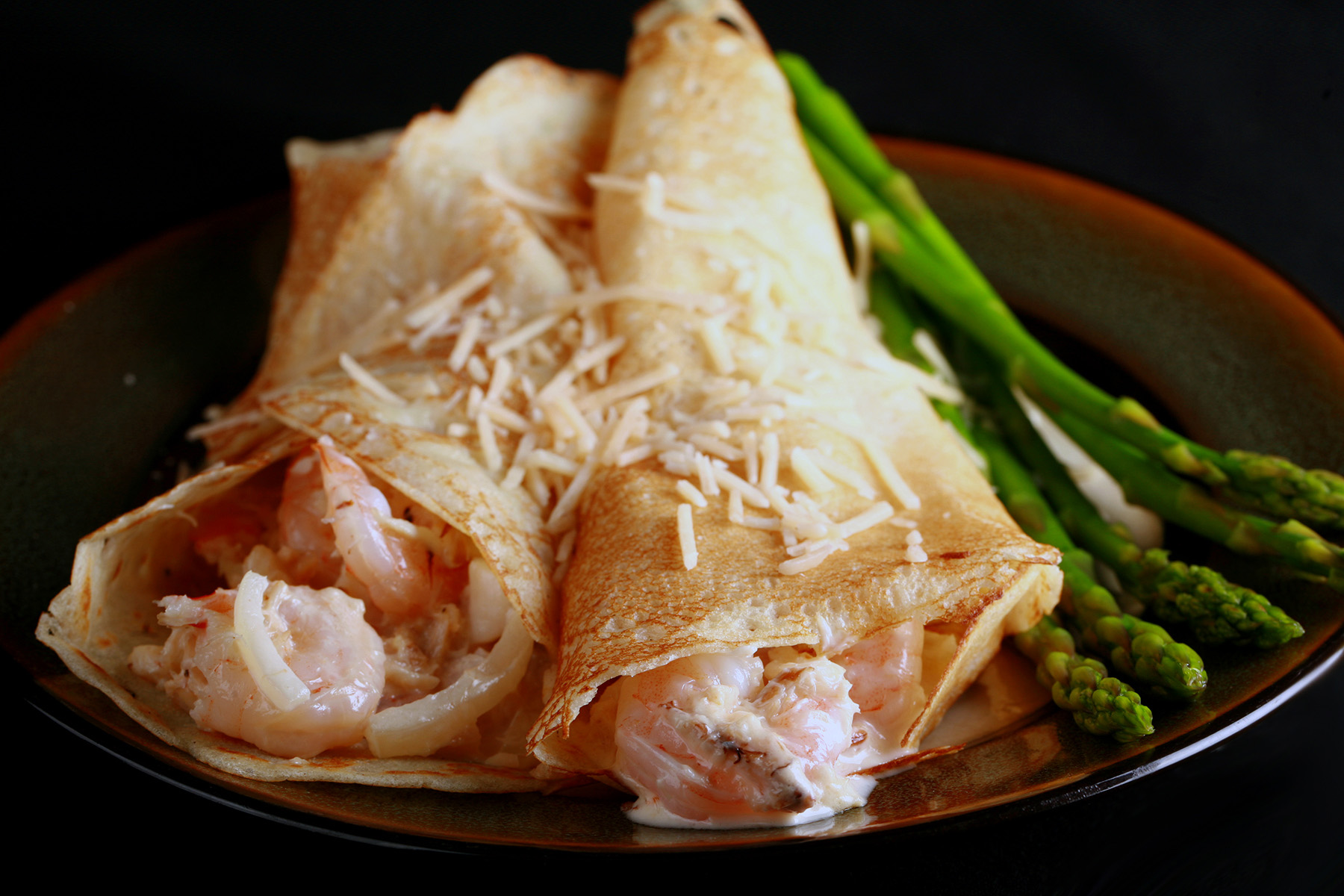 Two gluten free crepes stuffed with seafood and white wine sauce.