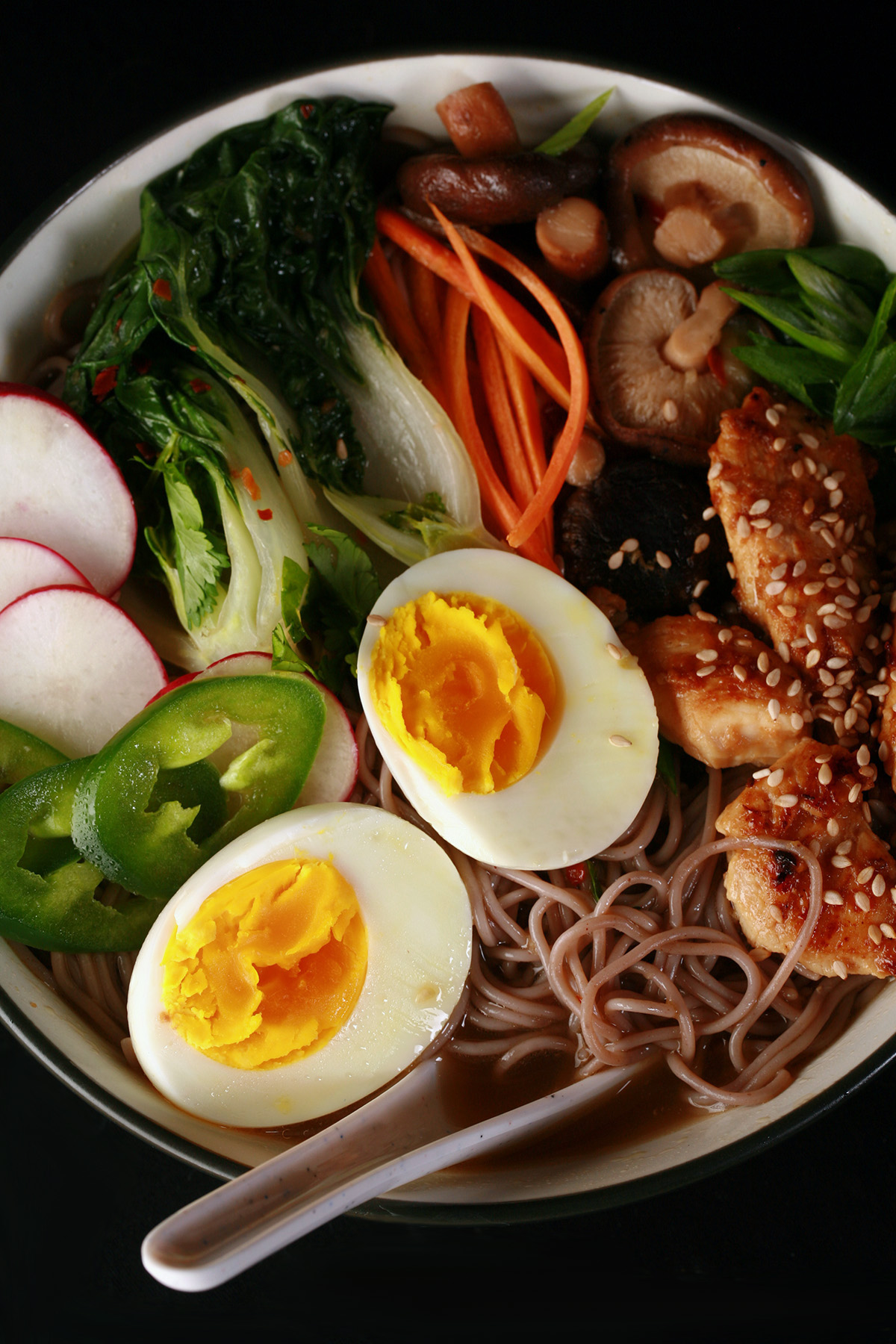 A bowl of gluten free ramen, with chicken and vegetables.
