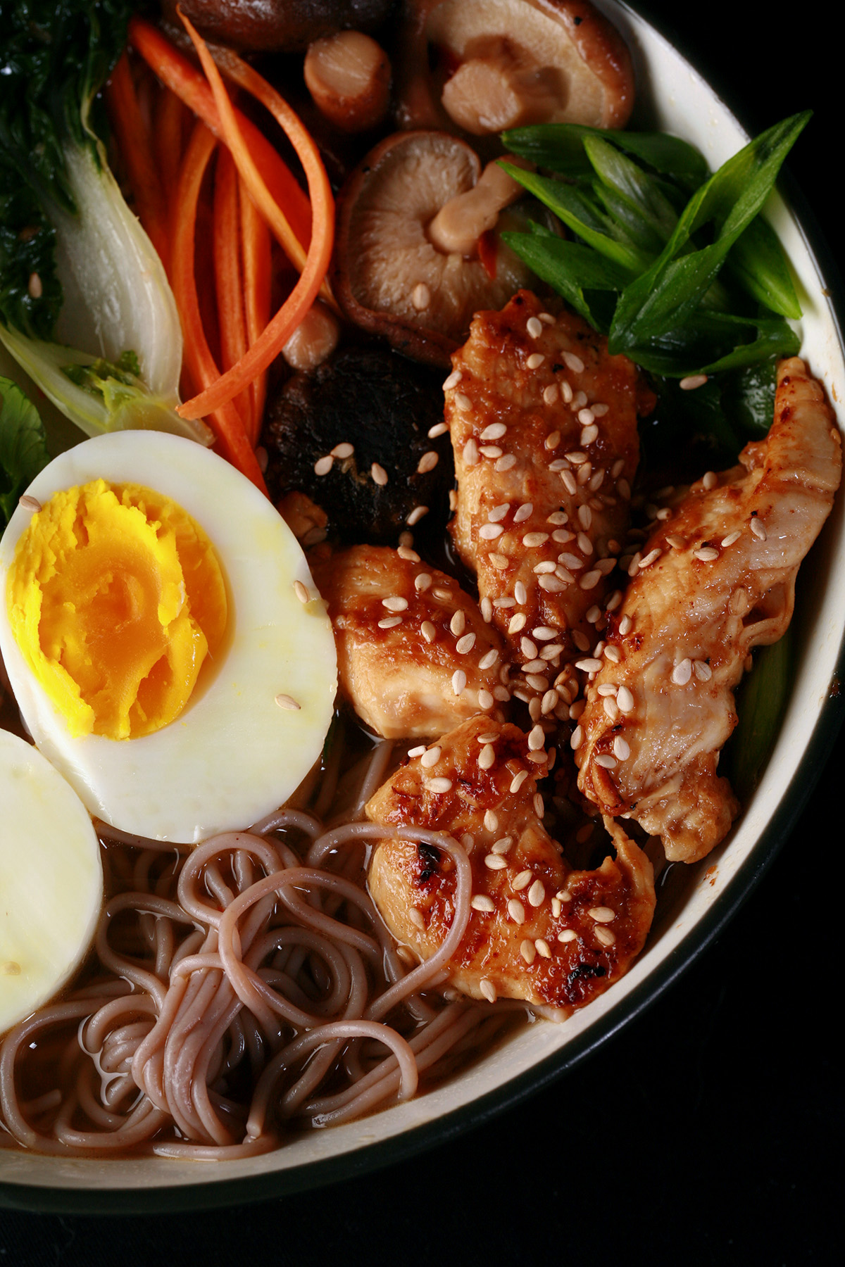 A bowl of gluten-free ramen, with chicken and vegetables.