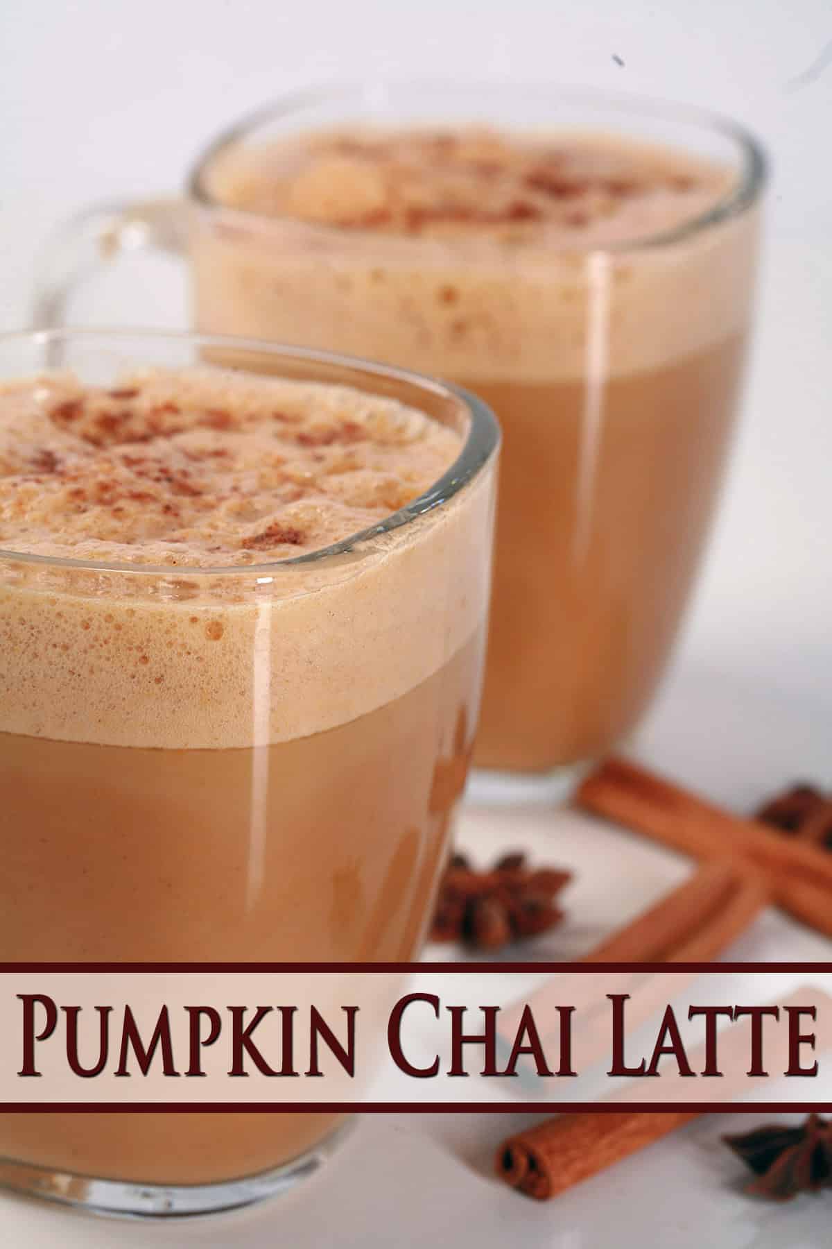 2 Pumpkin Chai Lattes in glass mugs, with cinnamon sticks and star anise around them.