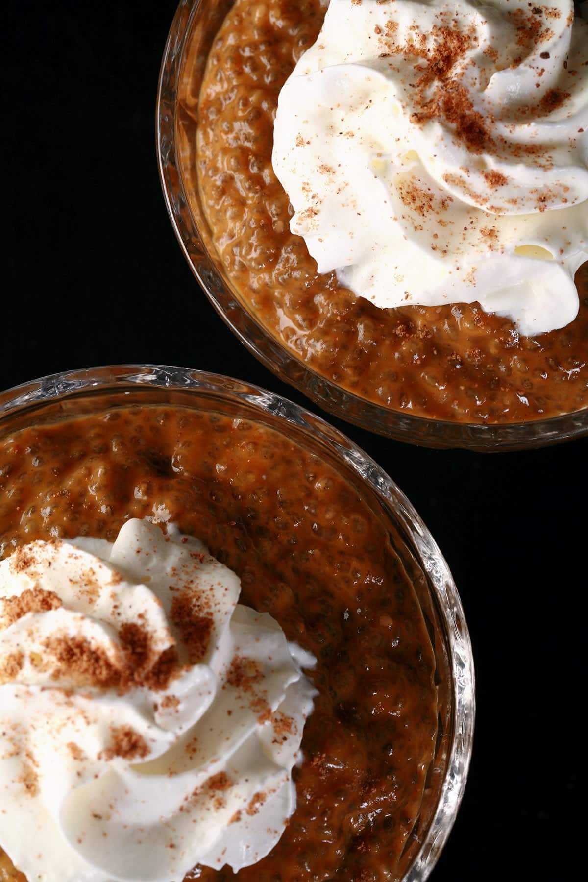 Pumpkin Pie Chia Seed Pudding in a glass cup, topped with whipped cream and nutmeg.