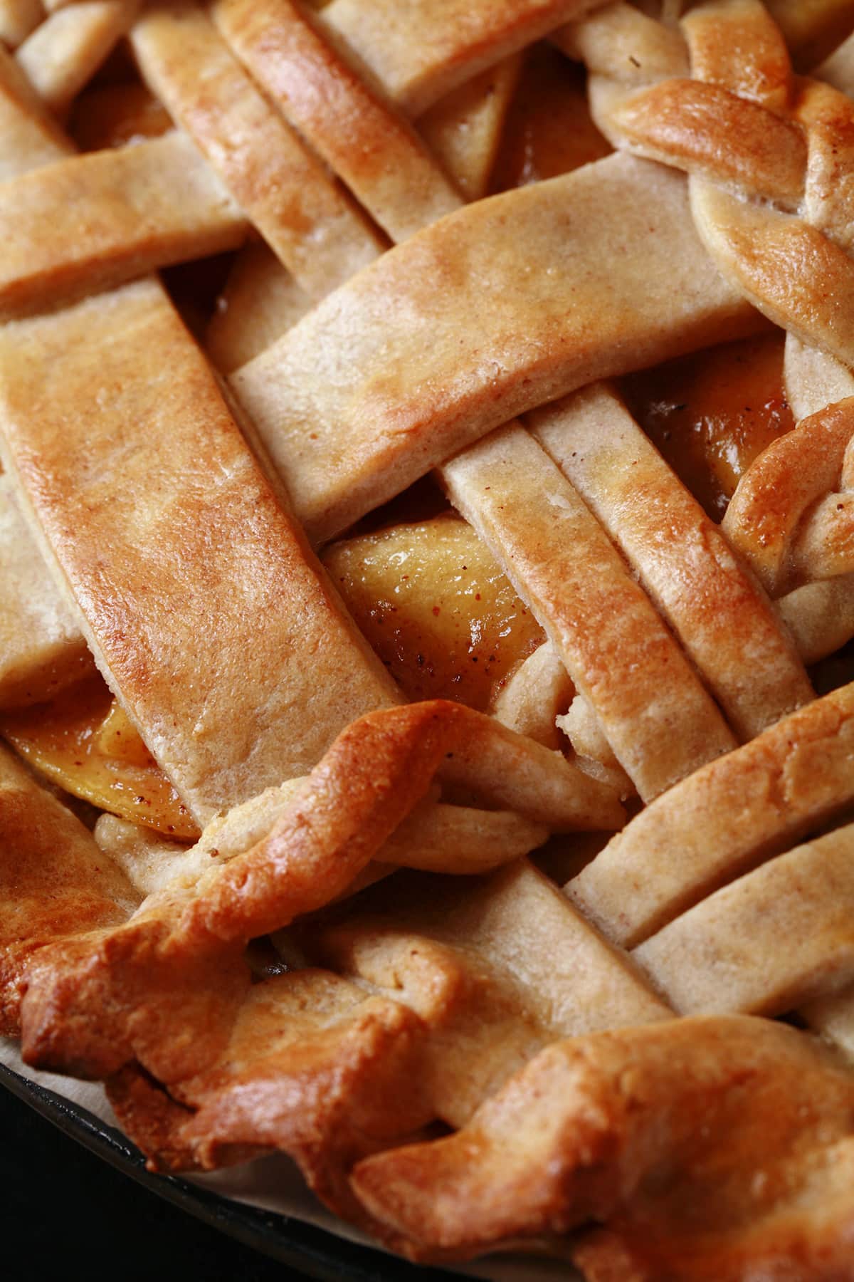 A close up view of a lattice topped pie, made with a gluten-free pie crust.