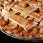 A close up view of a lattice topped pie, made with a gluten free pie crust.