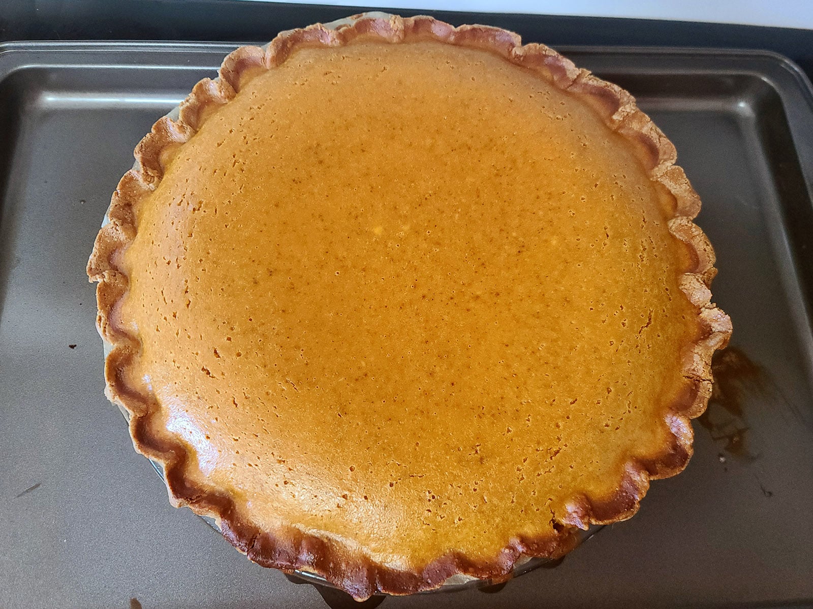 A puffy, freshly baked gluten free pumpkin pie.
