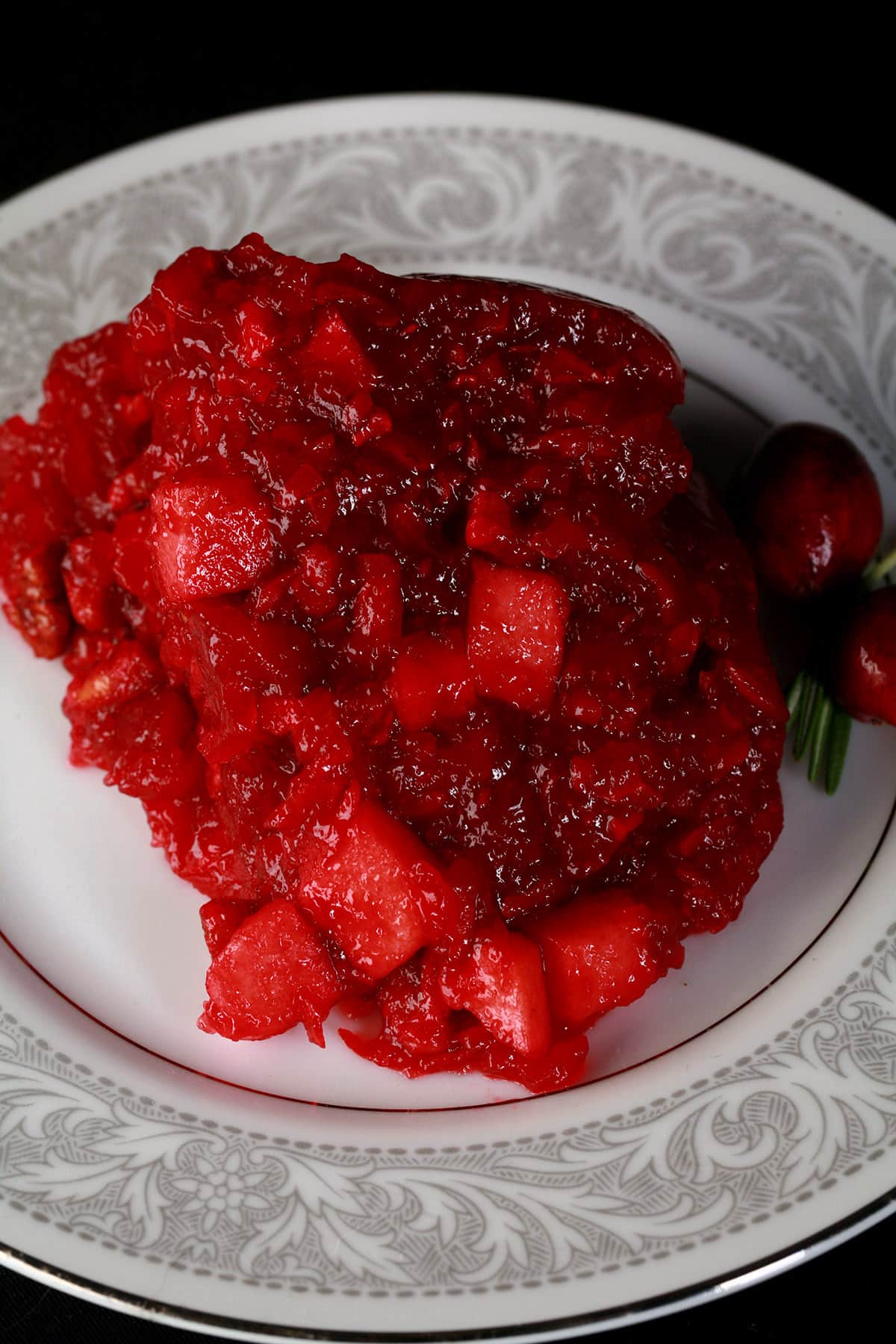 A serving of cranberry Jello salad on a plate.
