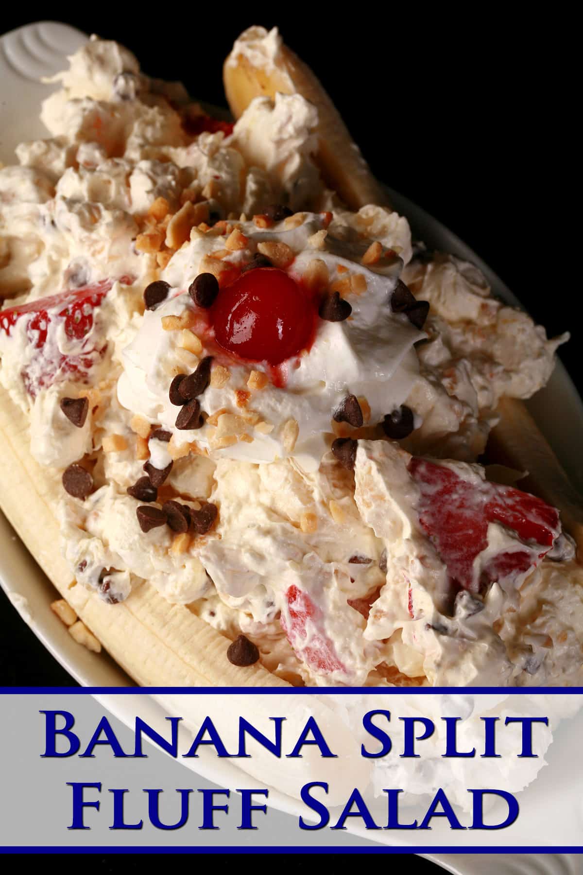 A large serving of banana split marshmallow salad, done up to look like a banana split.