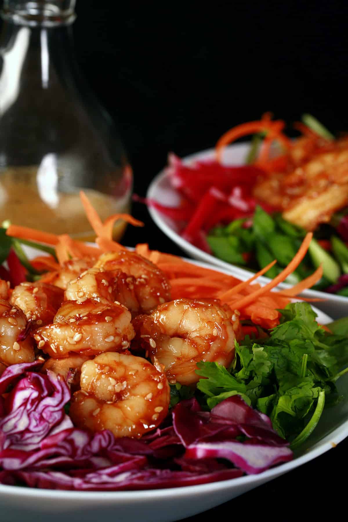 2 Honey ginger shrimp salads with a bottle of honey ginger vinaigrette.