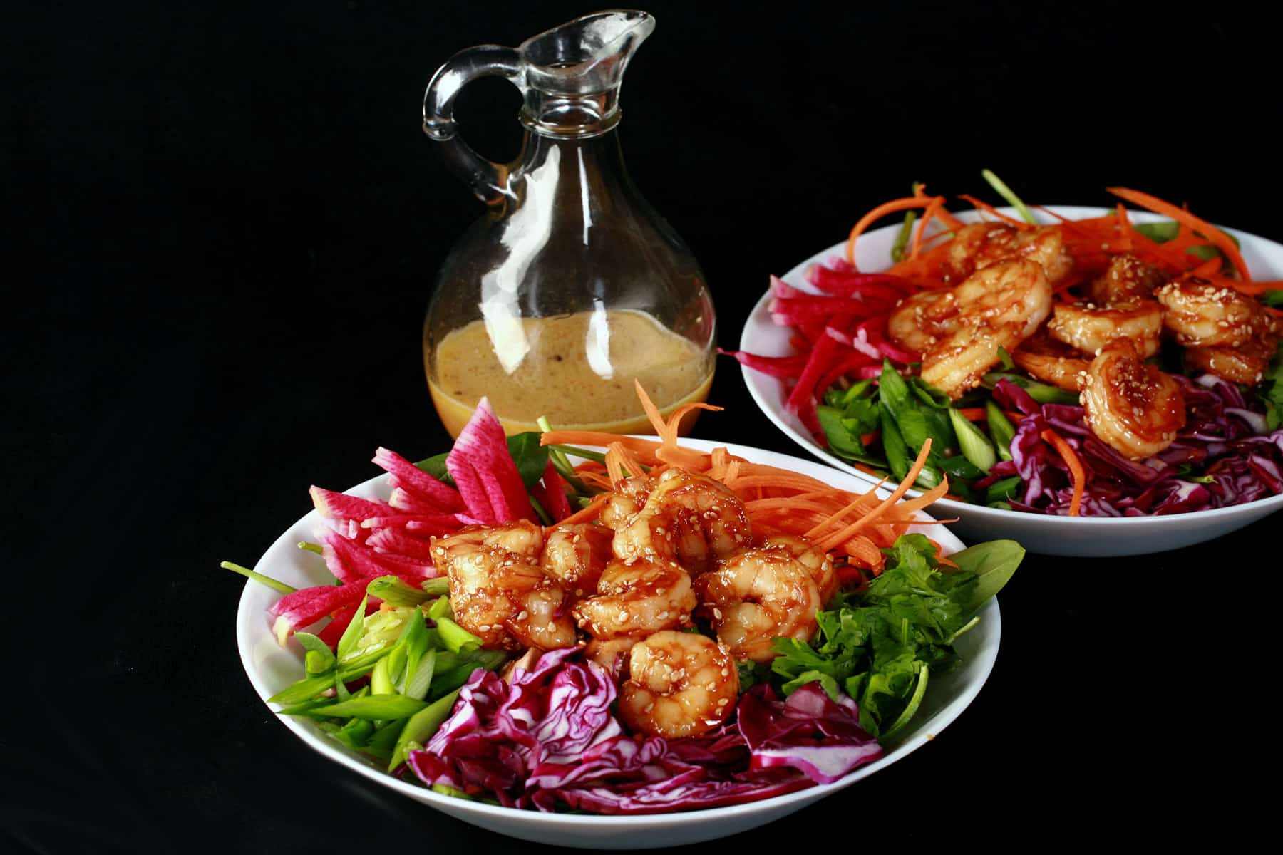 2 Honey ginger shrimp salads with a bottle of honey ginger vinaigrette.