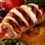 A grilled teriyaki chicken salad with fresh pineapple slices.