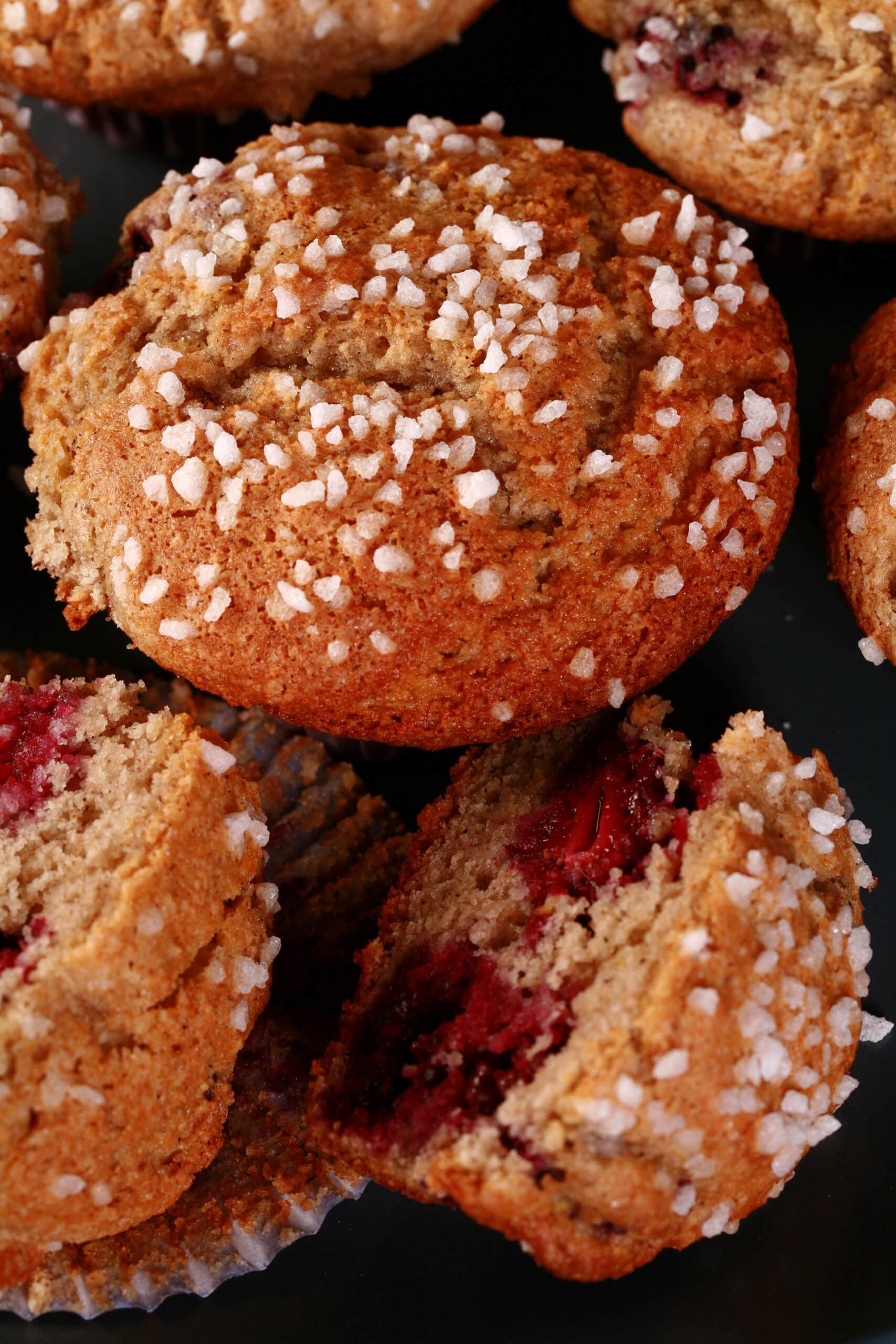 A plate of sugar crusted gluten free blackberry muffins.