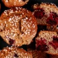 A plate of sugar crusted gluten free blackberry muffins.