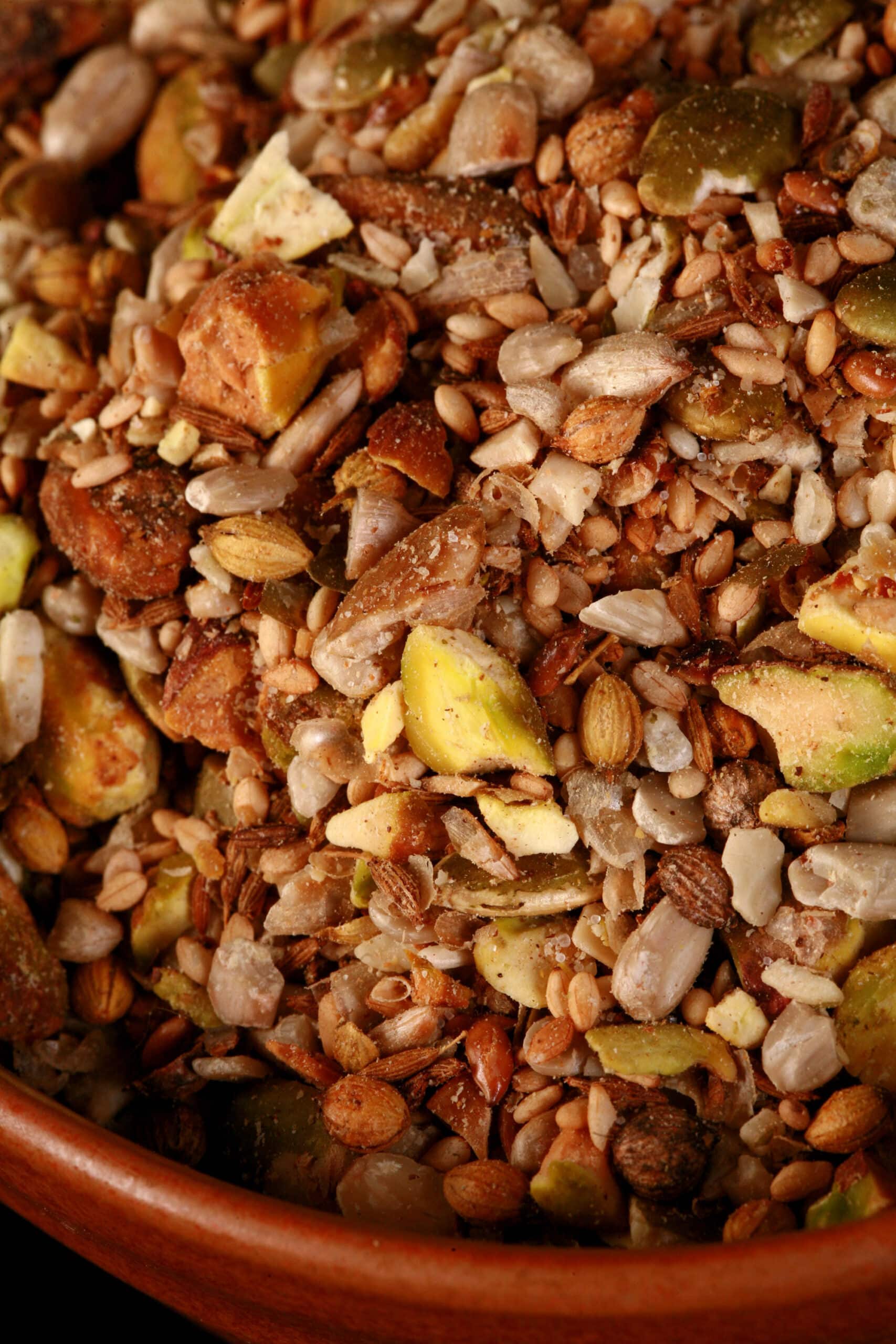 A small brown bowl of pistachio dukkag spice mix.