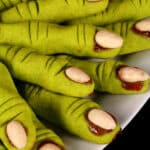 A plate of bright green gluten free witch finger cookies.