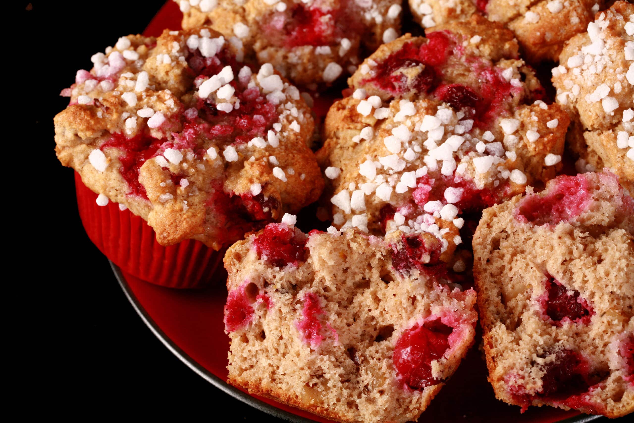 1 plate of gluten-free cranberry muffins with walnuts and a sugar crust on top.