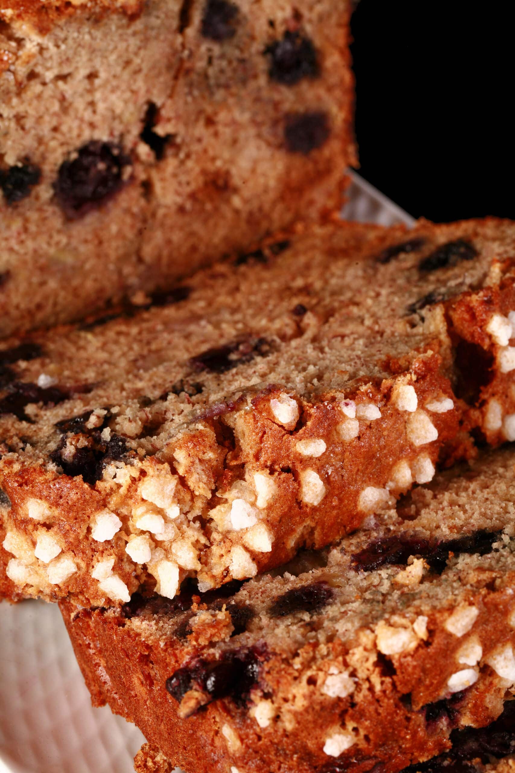 A sliced loaf of gluten free banana blueberry bread.