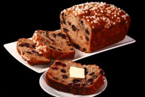 A sliced loaf of gluten free blueberry banana bread.