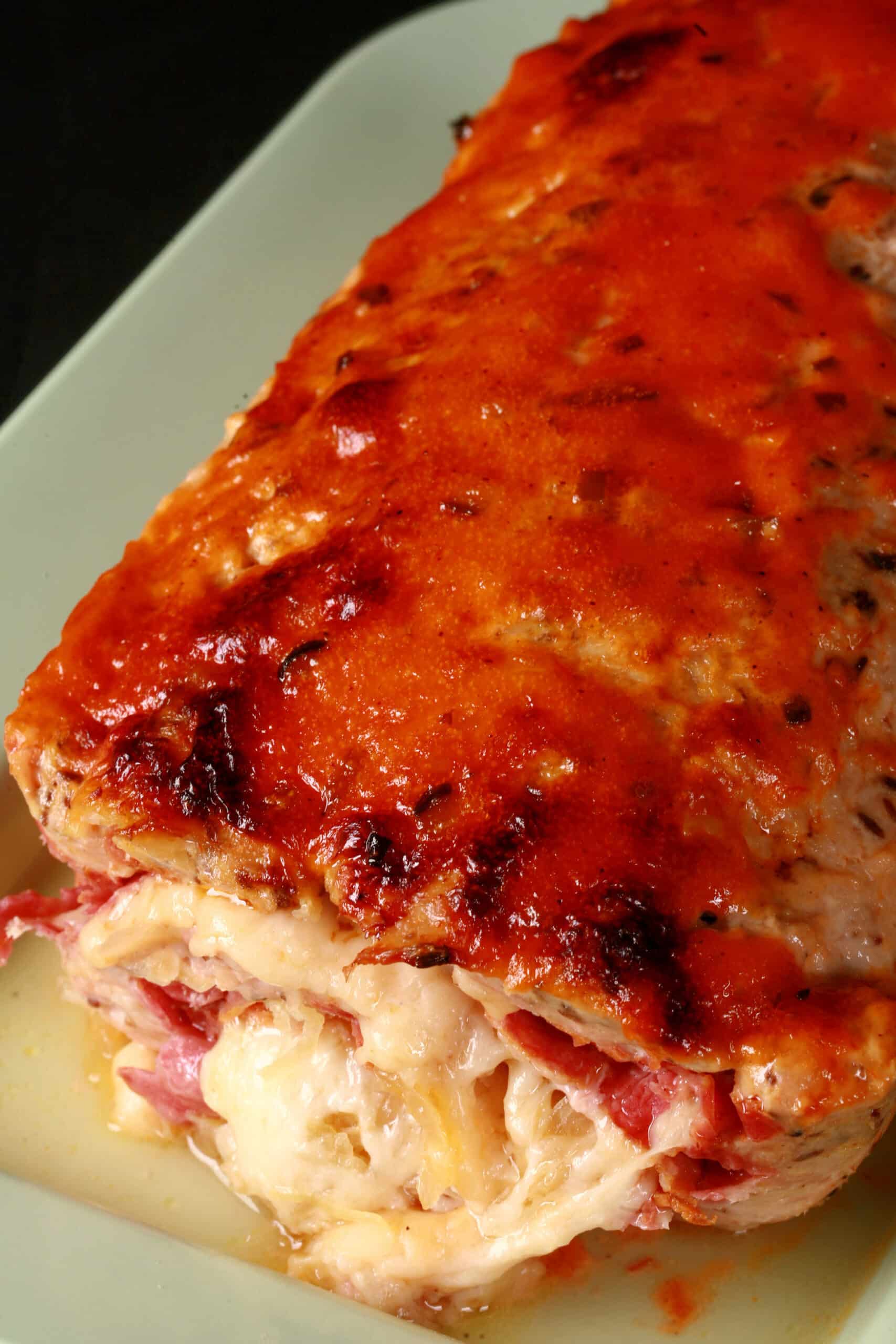 A whole Reuben Stuffed Meatloaf on a serving platter.