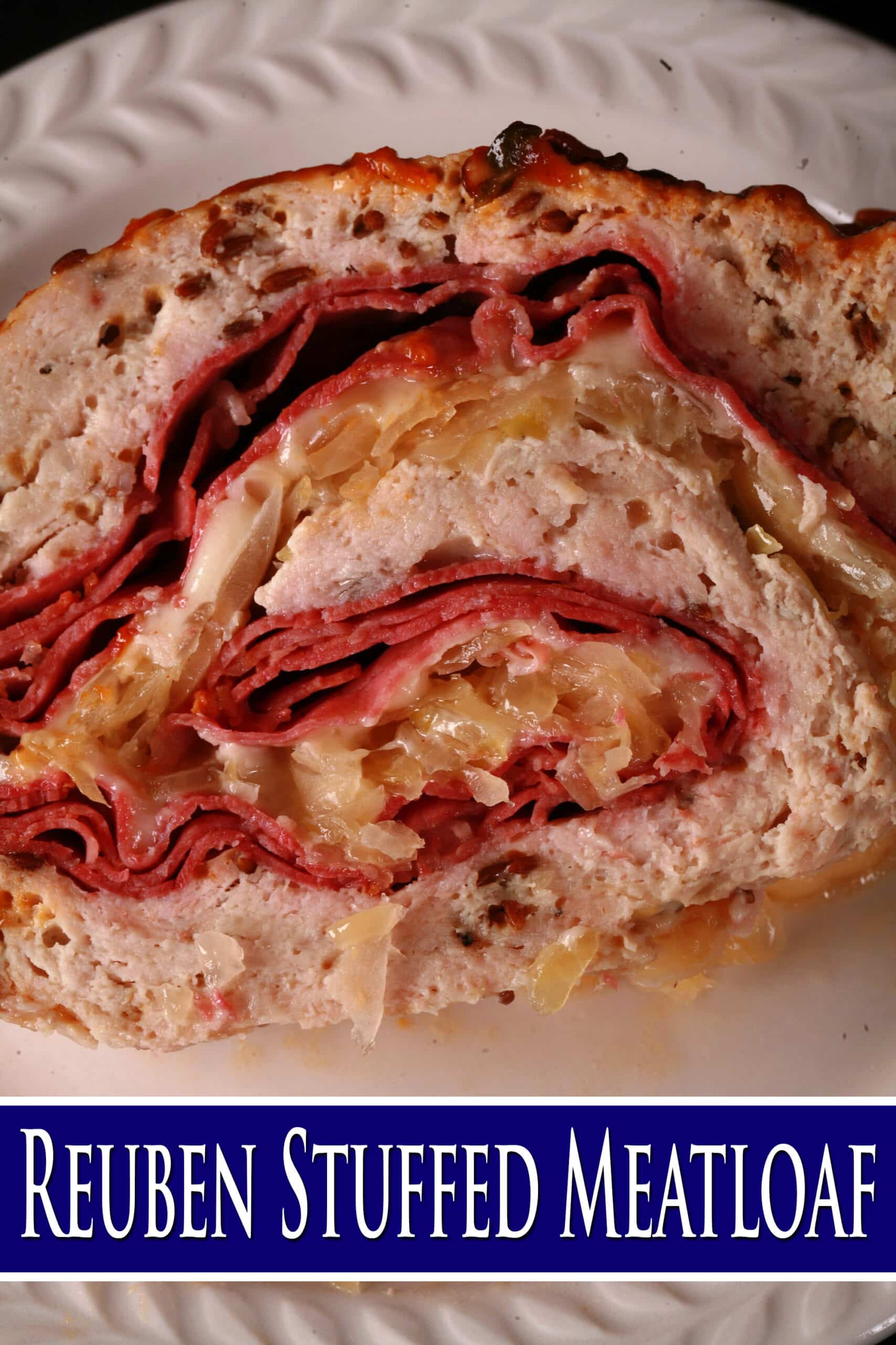 A slice of Reuben Meatloaf on a plate. Overlaid text says reuben stuffed meatloaf.