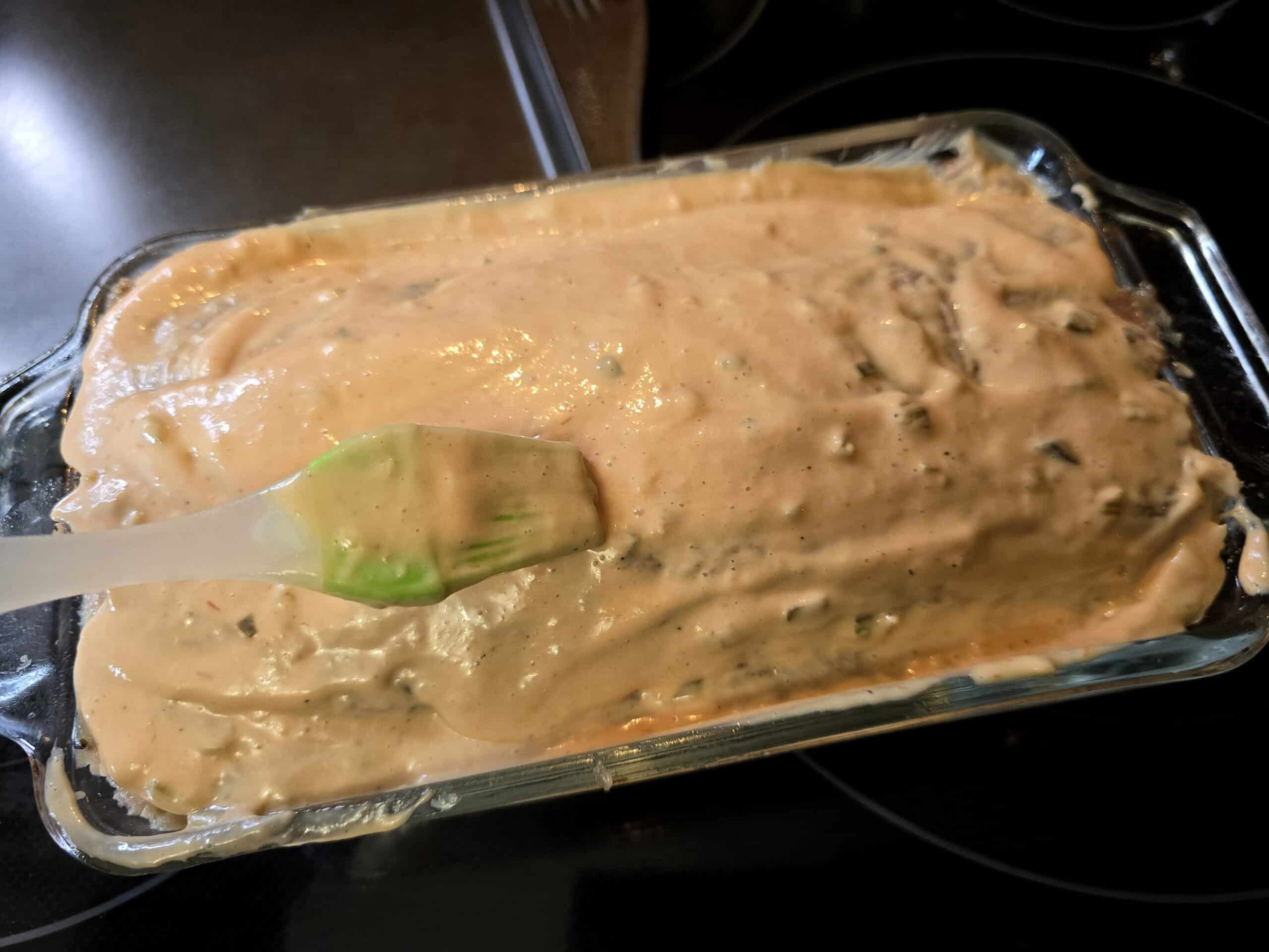 Thousand Island dressing being spread over the meatloaf