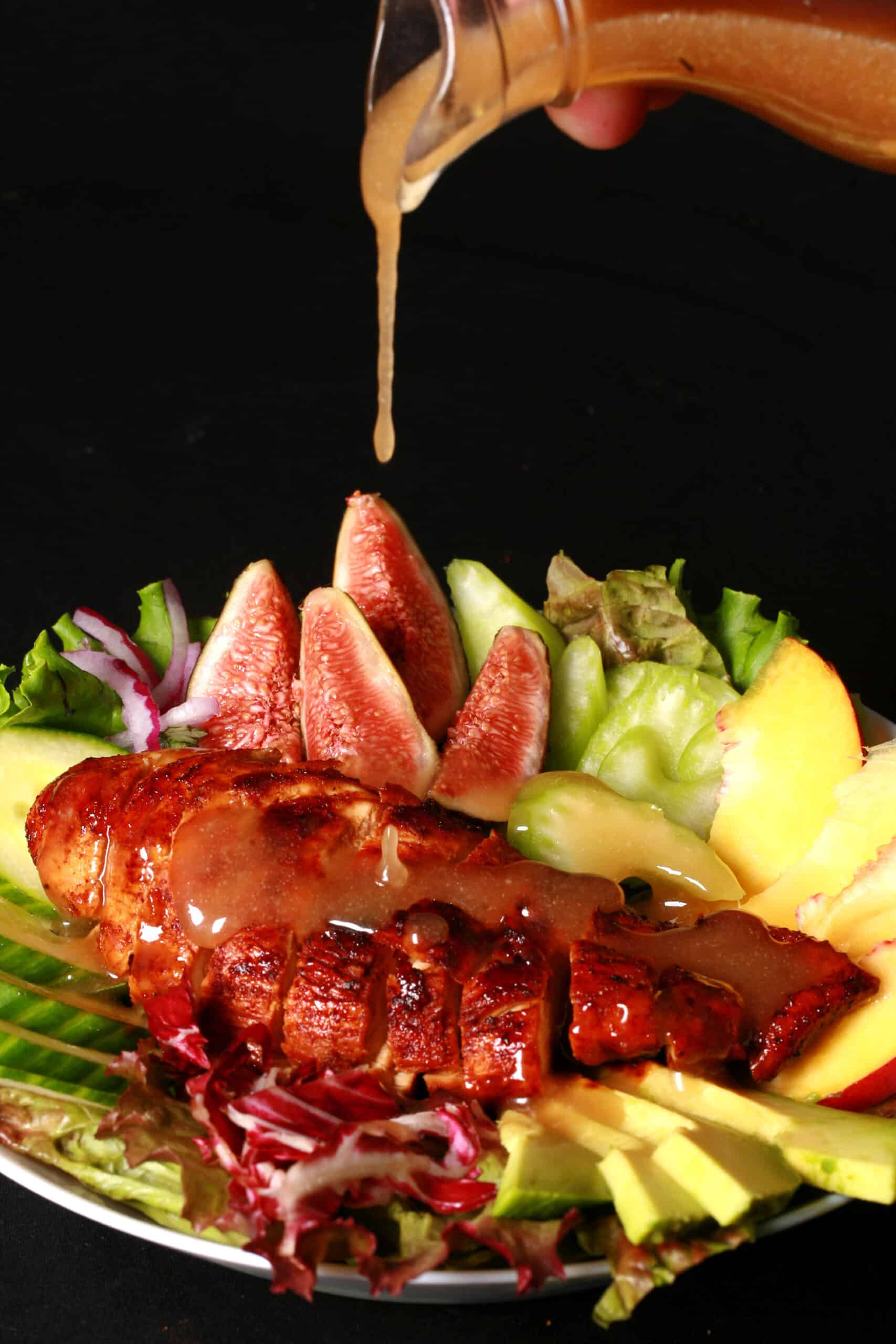 2 balsamic glazed chicken and peach salads, with peaches, figs, avocado, vegetables, and white peach balsamic vinegar glazed  chicken breast.