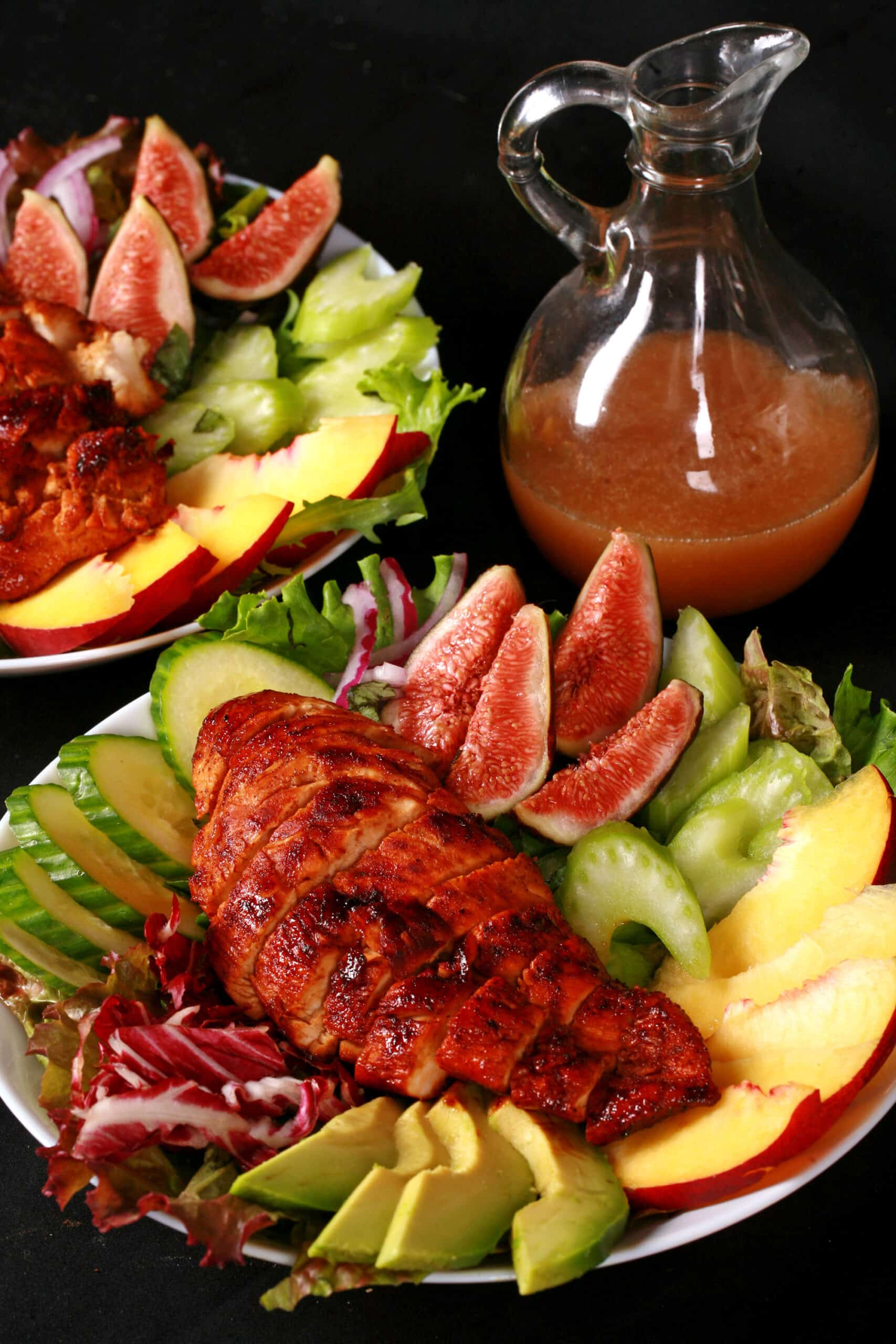 2 balsamic glazed chicken and peach salads, with peaches, figs, avocado, vegetables, and white peach balsamic vinegar glazed  chicken breast.