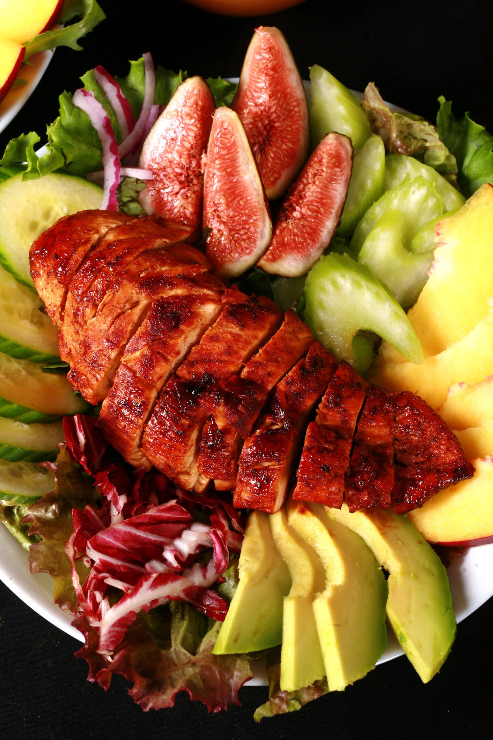 2 summer salads with peaches, figs, avocado, vegetables, and white peach balsamic vinegar glazed  chicken breast.