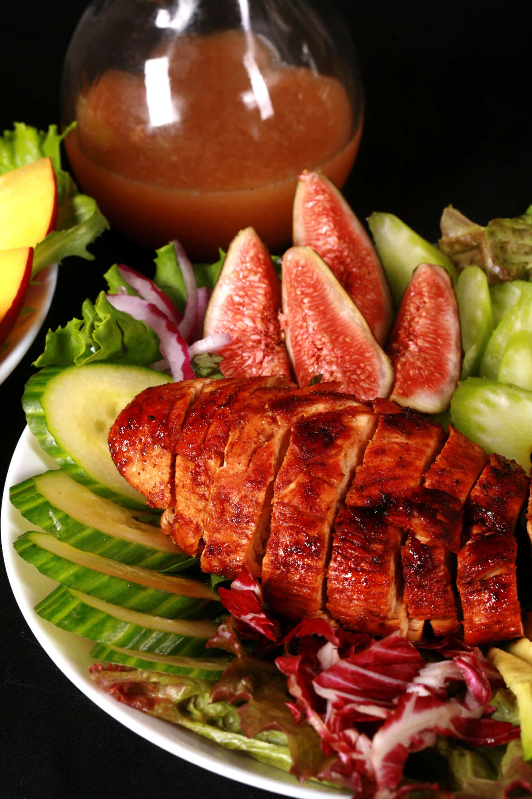 2 balsamic glazed chicken and peach salads, with peaches, figs, avocado, vegetables, and white peach balsamic vinegar glazed  chicken breast.