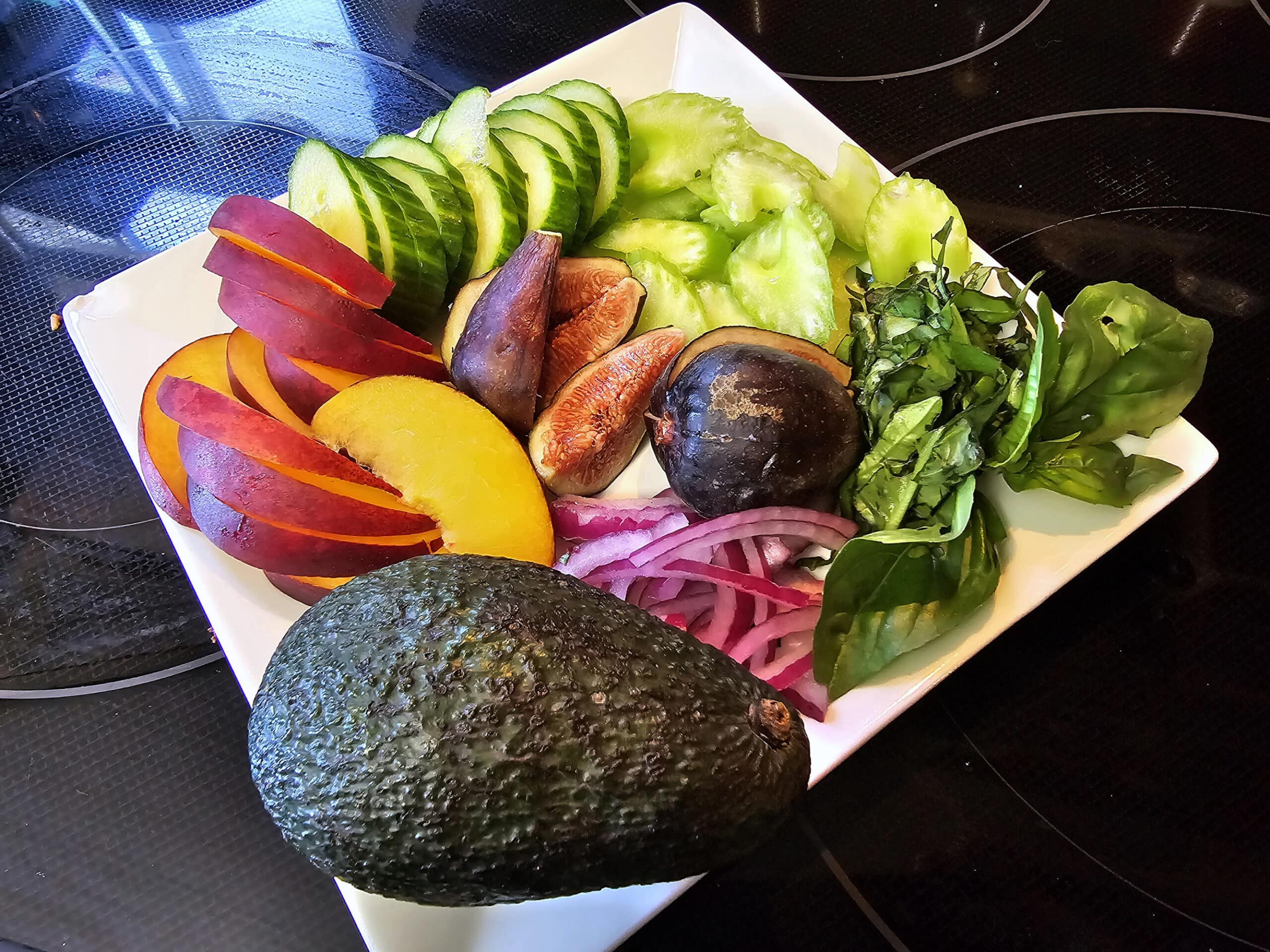 All of the salad toppings prepared and laid out on a plate.