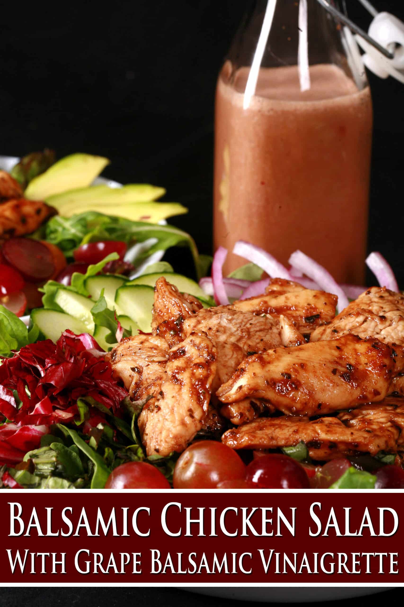 A jewel toned salad topped with balsamic glazed chicken and red grapes. Overlaid text says Balsamic chicken salad with grape balsamic vinaigrette.