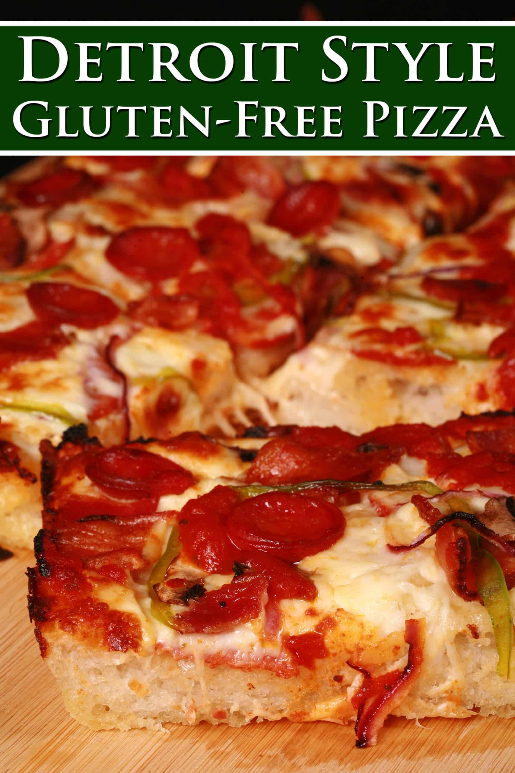 A cut slab of gluten free detroit style pizza with pepperoni, mushrooms, onion, bacon, and green peppers. Overlaid text says detroit style gluten free pizza.