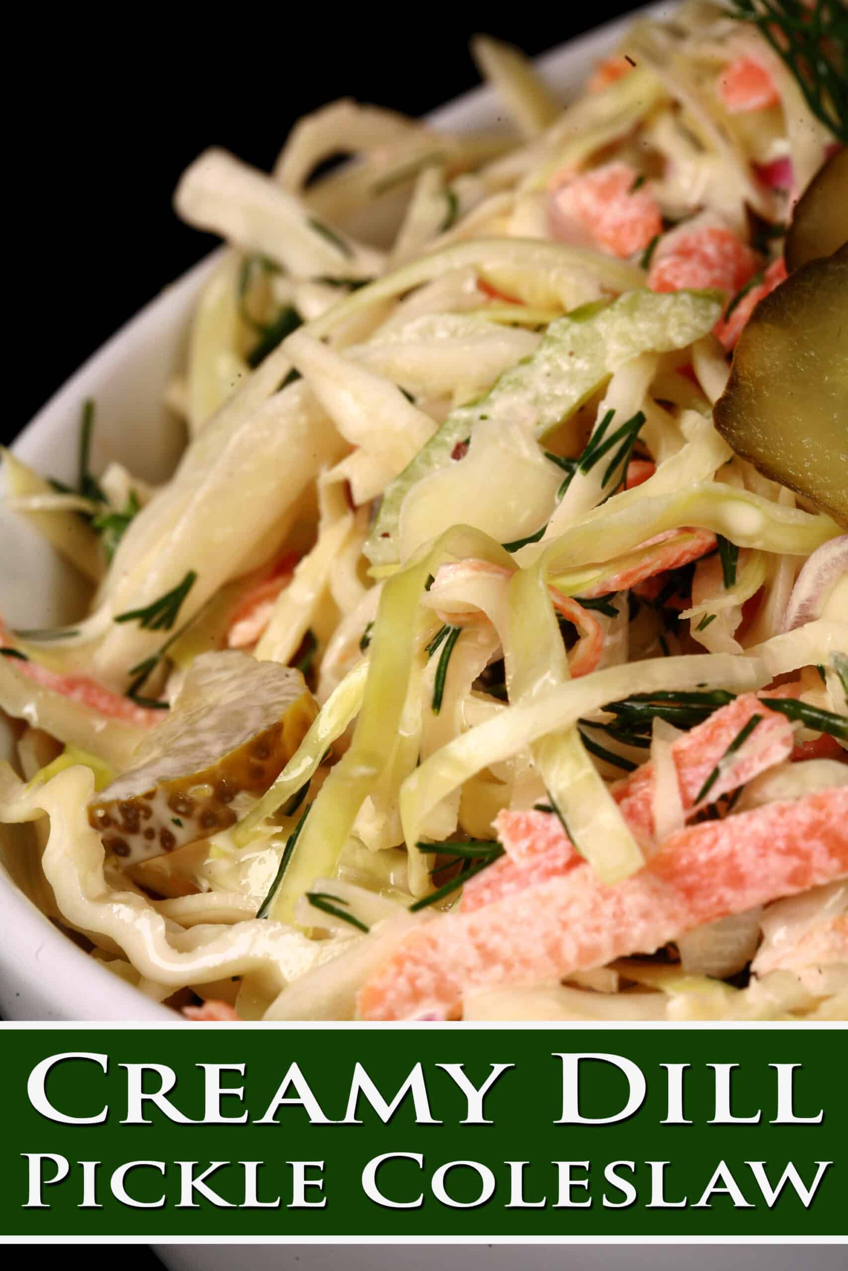A bowl of creamy coleslaw with cabbage, carrots, red onions, pickles, and more.  Overlaid text says creamy dill pickle coleslaw.