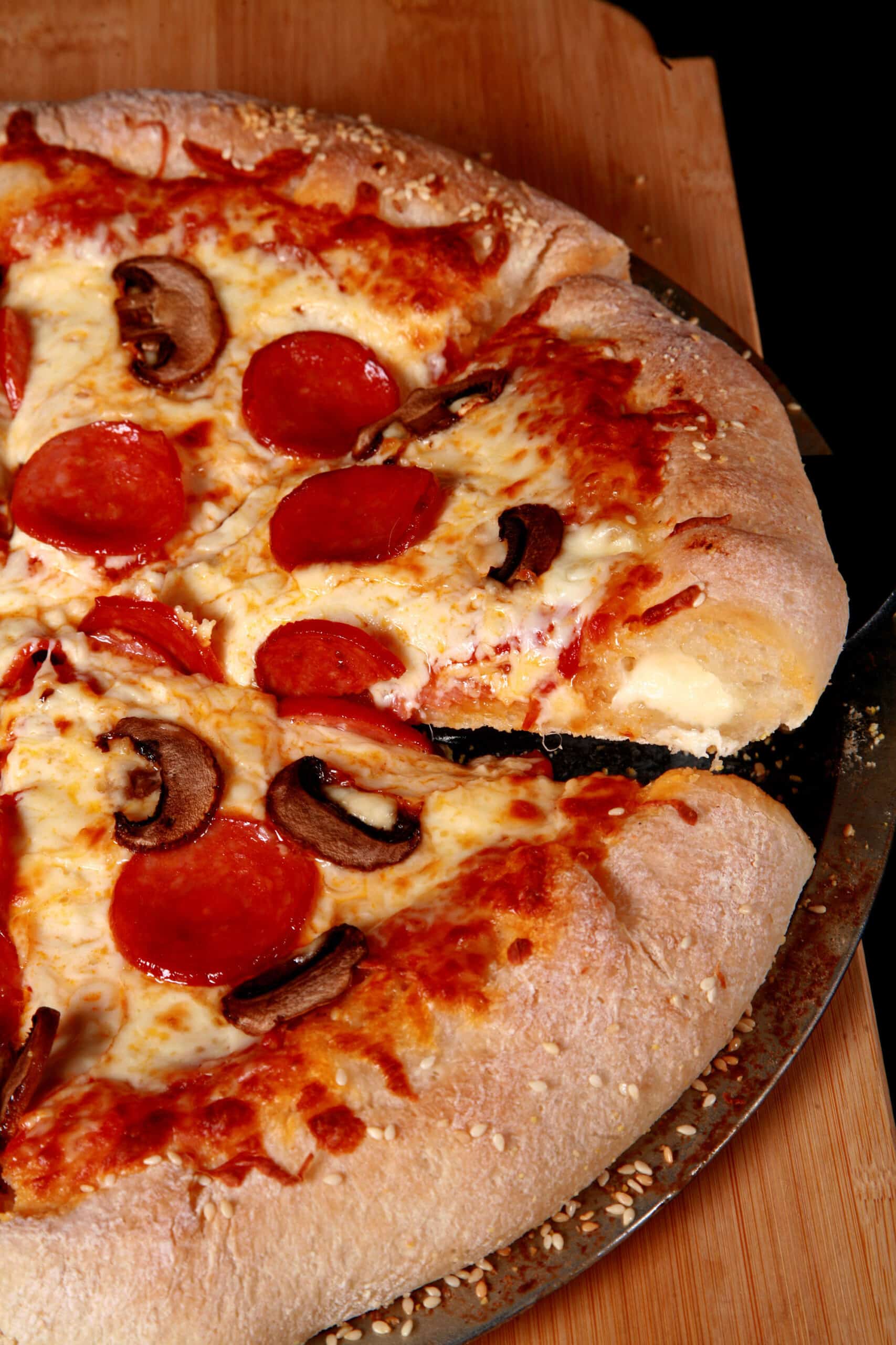 A stuffed crust gluten free pizza with pepperoni and mushrooms.