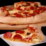 A gluten free stuffed crust pizza with pepperoni and mushrooms.