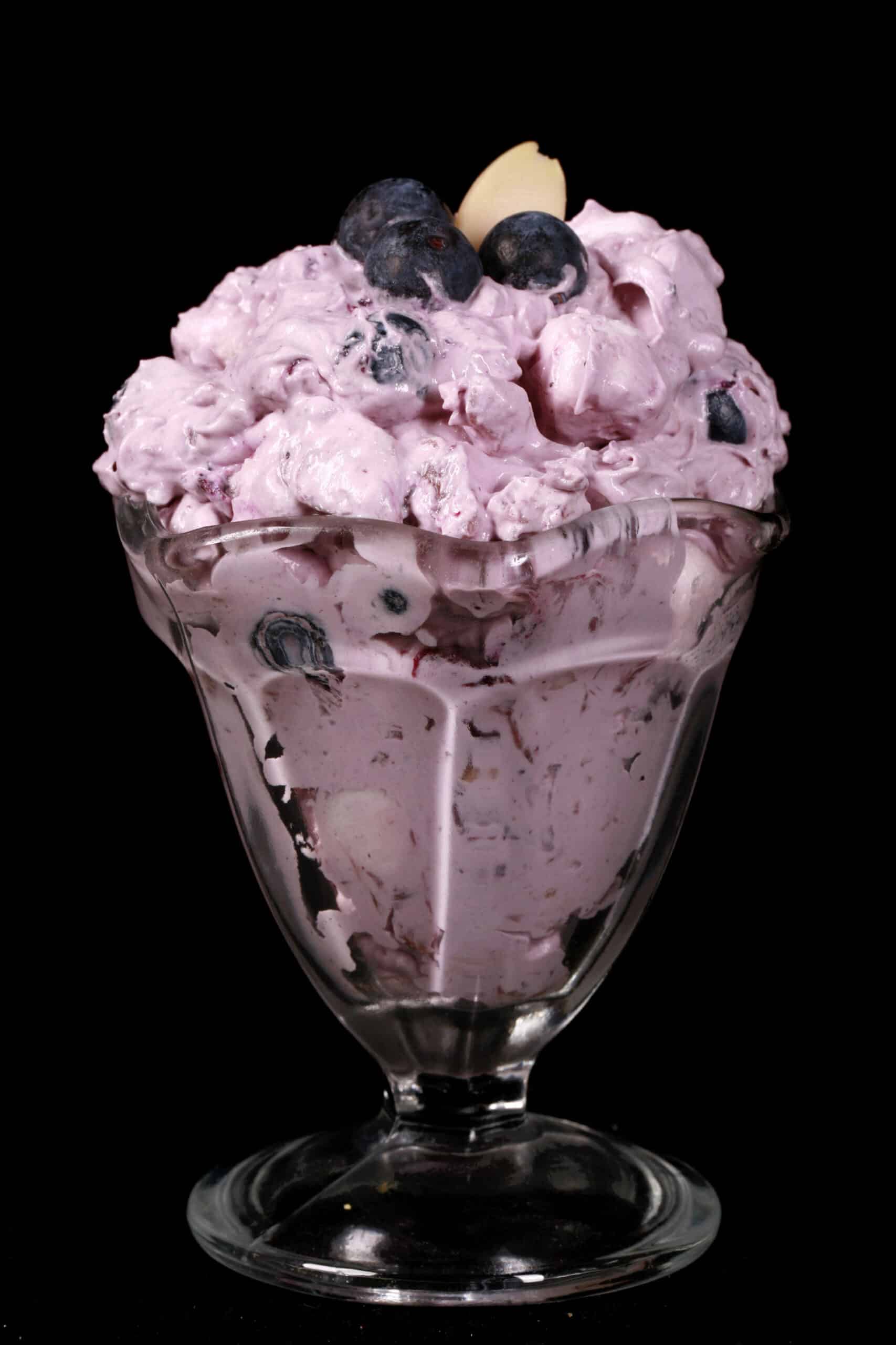 A bowl of blueberry and marshmallow fluff salad.
