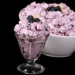 A bowl of blueberry and marshmallow fluff salad.